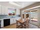 Bright kitchen featuring white cabinets, light blue backsplash, and a wood dining table at 1510 E Wescott Dr, Phoenix, AZ 85024