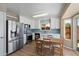 Updated kitchen with stainless steel appliances, white cabinets, and light blue backsplash at 1510 E Wescott Dr, Phoenix, AZ 85024