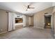 Bright living room with carpet flooring, white curtains, and a ceiling fan at 1510 E Wescott Dr, Phoenix, AZ 85024