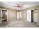 Spacious bedroom features a ceiling fan, carpeted floors, and a closet for ample storage at 1510 E Wescott Dr, Phoenix, AZ 85024