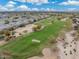 An aerial view overlooking a well-maintained golf course alongside a cozy residential community with lush green spaces at 15221 N Clubgate Dr # 2061, Scottsdale, AZ 85254