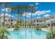 Beautiful pool area with palm trees, lounge chairs, and manicured landscaping creating a resort-like atmosphere at 15221 N Clubgate Dr # 2061, Scottsdale, AZ 85254