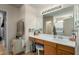 Bathroom vanity area with large mirror, vanity lighting, and wood-look flooring at 1622 E Silverbirch Ave, Buckeye, AZ 85326