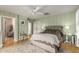 Comfortable bedroom with paneled walls, ceiling fan and view to other rooms at 1622 E Silverbirch Ave, Buckeye, AZ 85326