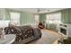 Inviting bedroom showcasing panelled walls, a ceiling fan, and a decorative fireplace at 1622 E Silverbirch Ave, Buckeye, AZ 85326