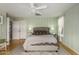 Comfortable bedroom with paneled walls, ceiling fan and double closets at 1622 E Silverbirch Ave, Buckeye, AZ 85326