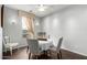 Cozy dining area with seating for four, natural light, and gray walls at 1622 E Silverbirch Ave, Buckeye, AZ 85326