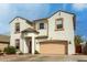 Two-story stucco home with a two-car garage, decorative trim, and landscaped front yard at 1622 E Silverbirch Ave, Buckeye, AZ 85326