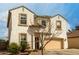 Two-story stucco home, featuring a two-car garage and mature landscaping in the front yard at 1622 E Silverbirch Ave, Buckeye, AZ 85326