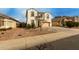 Stucco two-story home featuring a two-car garage and desert landscaping in a residential area at 1622 E Silverbirch Ave, Buckeye, AZ 85326
