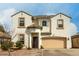 Charming two-story home features a welcoming front porch, two-car garage, and landscaped front yard at 1622 E Silverbirch Ave, Buckeye, AZ 85326