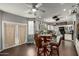 Open concept kitchen and dining area feature granite countertops and stainless steel appliances at 1622 E Silverbirch Ave, Buckeye, AZ 85326