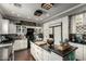 Beautiful kitchen features dark countertops, white cabinets, and modern stainless steel appliances at 1622 E Silverbirch Ave, Buckeye, AZ 85326