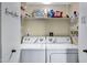 Convenient laundry room featuring a washer, dryer, and ample shelving for storage at 16624 E Palisades Blvd # 101, Fountain Hills, AZ 85268