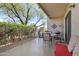 Relaxing patio area with seating, grill, view of surrounding trees, and partial shade at 16624 E Palisades Blvd # 101, Fountain Hills, AZ 85268