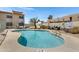 Community pool with clear blue water, lounge chairs, and well-maintained landscaping at 16624 E Palisades Blvd # 101, Fountain Hills, AZ 85268