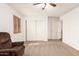 Spacious bedroom with neutral carpet, a ceiling fan, and a closet with sliding doors at 1805 E Sagebrush St, Gilbert, AZ 85296