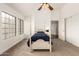 Carpeted bedroom with ceiling fan and natural light at 1805 E Sagebrush St, Gilbert, AZ 85296