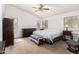 Bright bedroom with vaulted ceilings and carpeted floor, furnished with a large bed and matching dressers at 1805 E Sagebrush St, Gilbert, AZ 85296