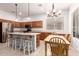 Bright eat-in kitchen with stainless steel appliances, an island with seating, and warm wood cabinetry at 1805 E Sagebrush St, Gilbert, AZ 85296