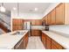 Updated kitchen with stainless steel appliances, wood cabinets, and a spacious island with sink and dishwasher at 1805 E Sagebrush St, Gilbert, AZ 85296