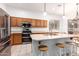 Spacious kitchen featuring stainless steel appliances, wood cabinets, and a central island with bar stool seating at 1805 E Sagebrush St, Gilbert, AZ 85296