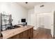 Home office with a large wooden desk, hardwood floors, and a shelf for books at 1805 E Sagebrush St, Gilbert, AZ 85296