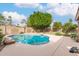 Backyard features a pool, patio, and well-manicured landscaping with mature trees at 1805 E Sagebrush St, Gilbert, AZ 85296