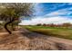 Scenic golf course view with a paved path winding through lush greenery and mature trees at 18610 E Amarado Cir, Rio Verde, AZ 85263