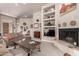 Inviting living room with a fireplace, built-in shelving, and comfortable seating at 18610 E Amarado Cir, Rio Verde, AZ 85263