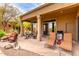 Inviting covered patio featuring outdoor seating, a dining table, and a barbecue grill at 18610 E Amarado Cir, Rio Verde, AZ 85263