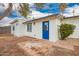 Exterior view of a well-maintained home with a blue door and a spacious backyard at 1900 S Coconino Dr, Apache Junction, AZ 85120
