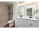 Well-lit bathroom featuring double vanities, modern fixtures, and a tiled shower at 1900 S Coconino Dr, Apache Junction, AZ 85120