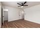 Bedroom boasts wood-look flooring, a ceiling fan, and access to a closet, combining style and functionality at 1900 S Coconino Dr, Apache Junction, AZ 85120