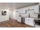 Updated kitchen with white cabinets, stainless steel appliances, and hardwood flooring at 1900 S Coconino Dr, Apache Junction, AZ 85120