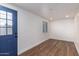 Bright living room features wood-look flooring and a window, providing a welcoming and versatile space at 1900 S Coconino Dr, Apache Junction, AZ 85120