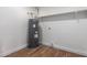 Features a hot water heater with wood-look flooring and a shelf, providing essential functionality at 1900 S Coconino Dr, Apache Junction, AZ 85120