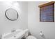 This bathroom features a sleek round mirror and a modern, efficient toilet at 19013 E Seagull Dr, Queen Creek, AZ 85142
