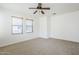 Spacious bedroom featuring neutral carpet and ceiling fan for added comfort at 19013 E Seagull Dr, Queen Creek, AZ 85142