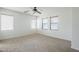 Large bedroom featuring carpeted floors, white walls, and natural light at 19013 E Seagull Dr, Queen Creek, AZ 85142