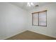 Carpeted bedroom with a ceiling fan and natural light from the window at 19013 E Seagull Dr, Queen Creek, AZ 85142