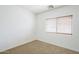 Bright bedroom with a window providing natural light and neutral carpet at 19013 E Seagull Dr, Queen Creek, AZ 85142
