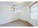 Bright and airy bedroom with neutral carpet and multiple windows bringing in natural light at 19013 E Seagull Dr, Queen Creek, AZ 85142