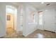 Bright foyer with tile floors, a white door, and arched doorways leading to other rooms at 19013 E Seagull Dr, Queen Creek, AZ 85142