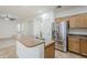 Bright kitchen showcasing a stainless steel refrigerator and breakfast bar with a sink at 19013 E Seagull Dr, Queen Creek, AZ 85142
