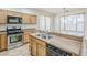 Well-lit kitchen featuring stainless steel appliances, wood cabinets and a tile floor at 19013 E Seagull Dr, Queen Creek, AZ 85142