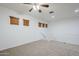Second-floor landing featuring carpeted floors, white walls and a ceiling fan at 19013 E Seagull Dr, Queen Creek, AZ 85142