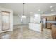 Open concept living room featuring tiled floors, stainless steel appliances and a view to the outdoor patio at 19013 E Seagull Dr, Queen Creek, AZ 85142