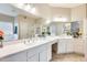 Bright bathroom featuring dual sinks, a bathtub, and a separate shower at 20630 N 42Nd Ave, Glendale, AZ 85308