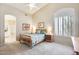 Bedroom features a neutral color palette, vaulted ceiling, and shuttered window at 20630 N 42Nd Ave, Glendale, AZ 85308
